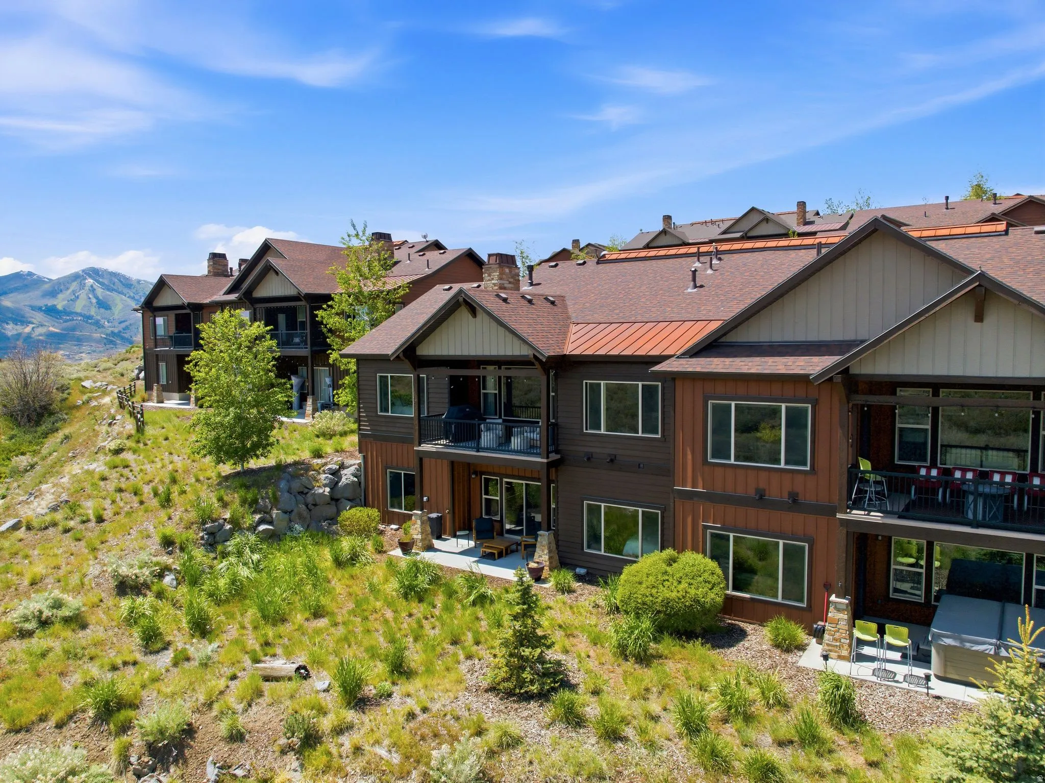 Terraced multi-level residences featuring warm wood-tone siding and complementary roofing