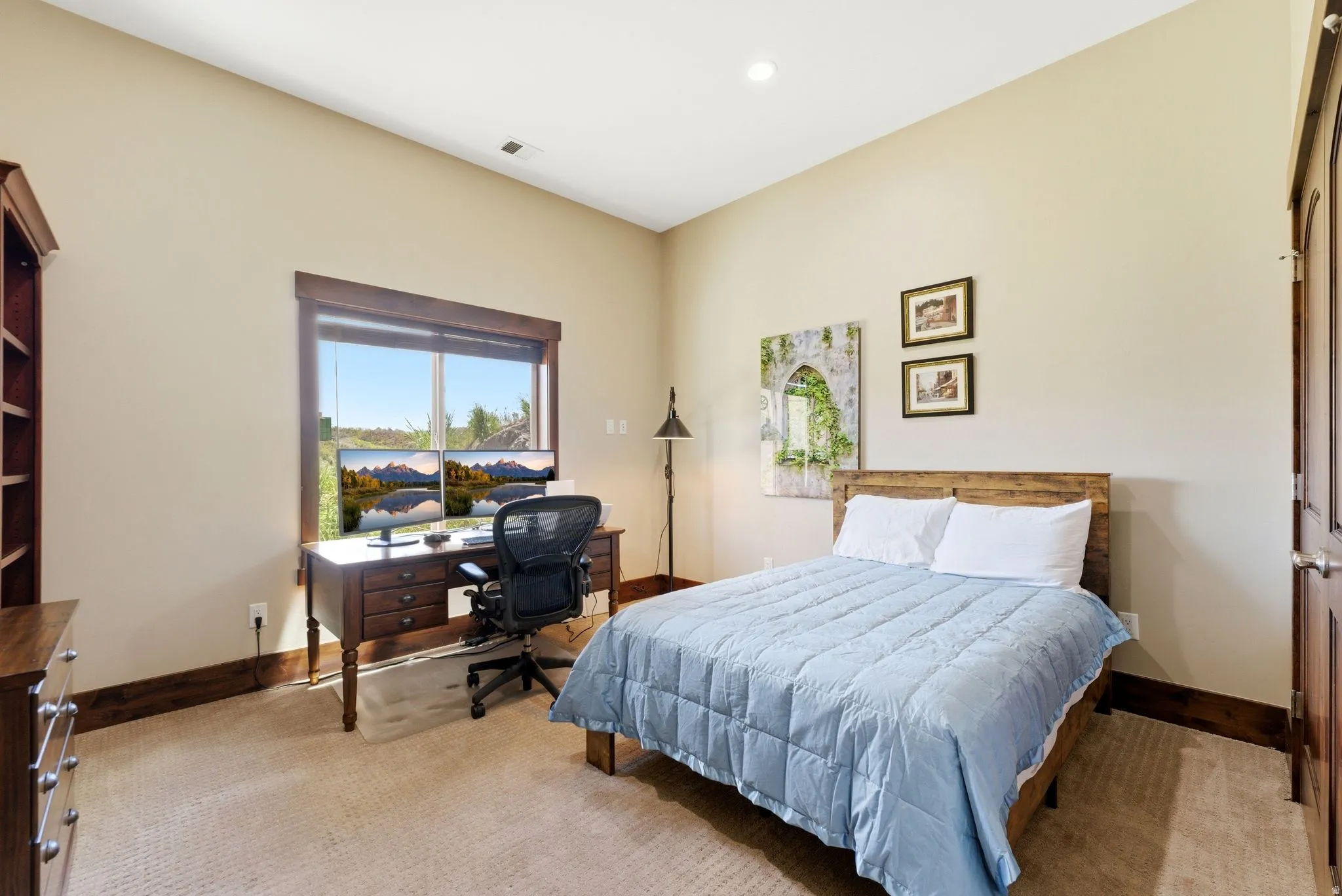 Spacious room featuring a large window, recessed lighting, and a neutral wall color