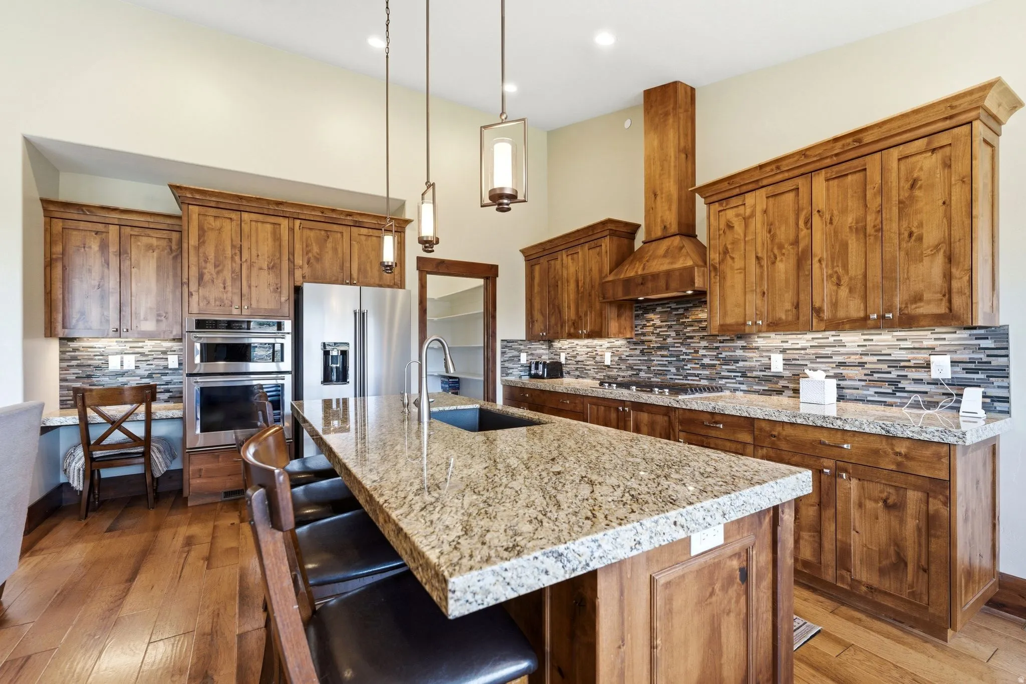 Well-appointed kitchen featuring wood-finish cabinetry and a spacious island with a built-in sink
