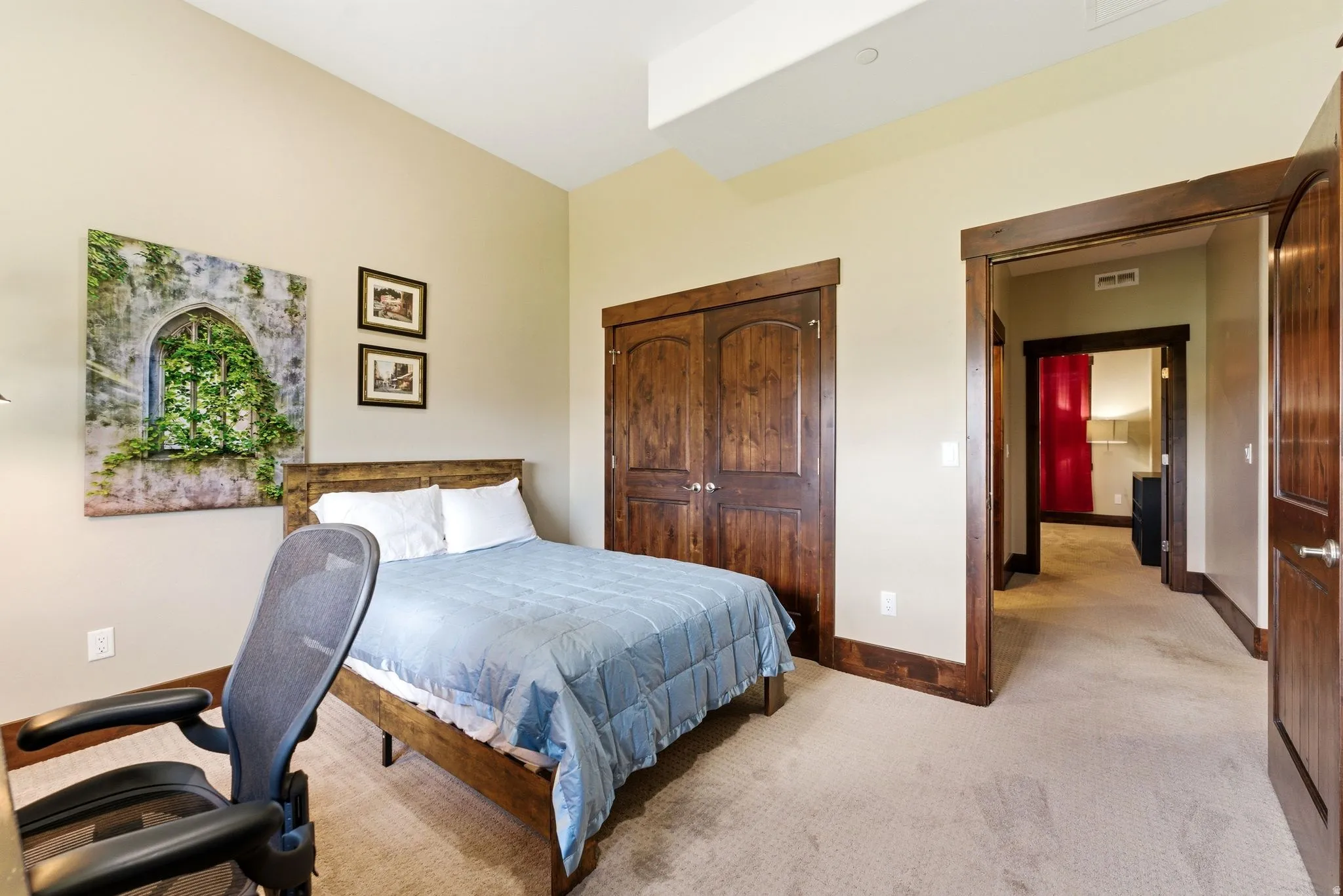 Bedroom with neutral wall color and carpeted flooring