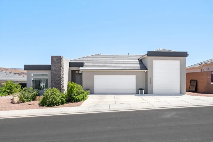 Contemporary stucco exterior with a stone veneer accent