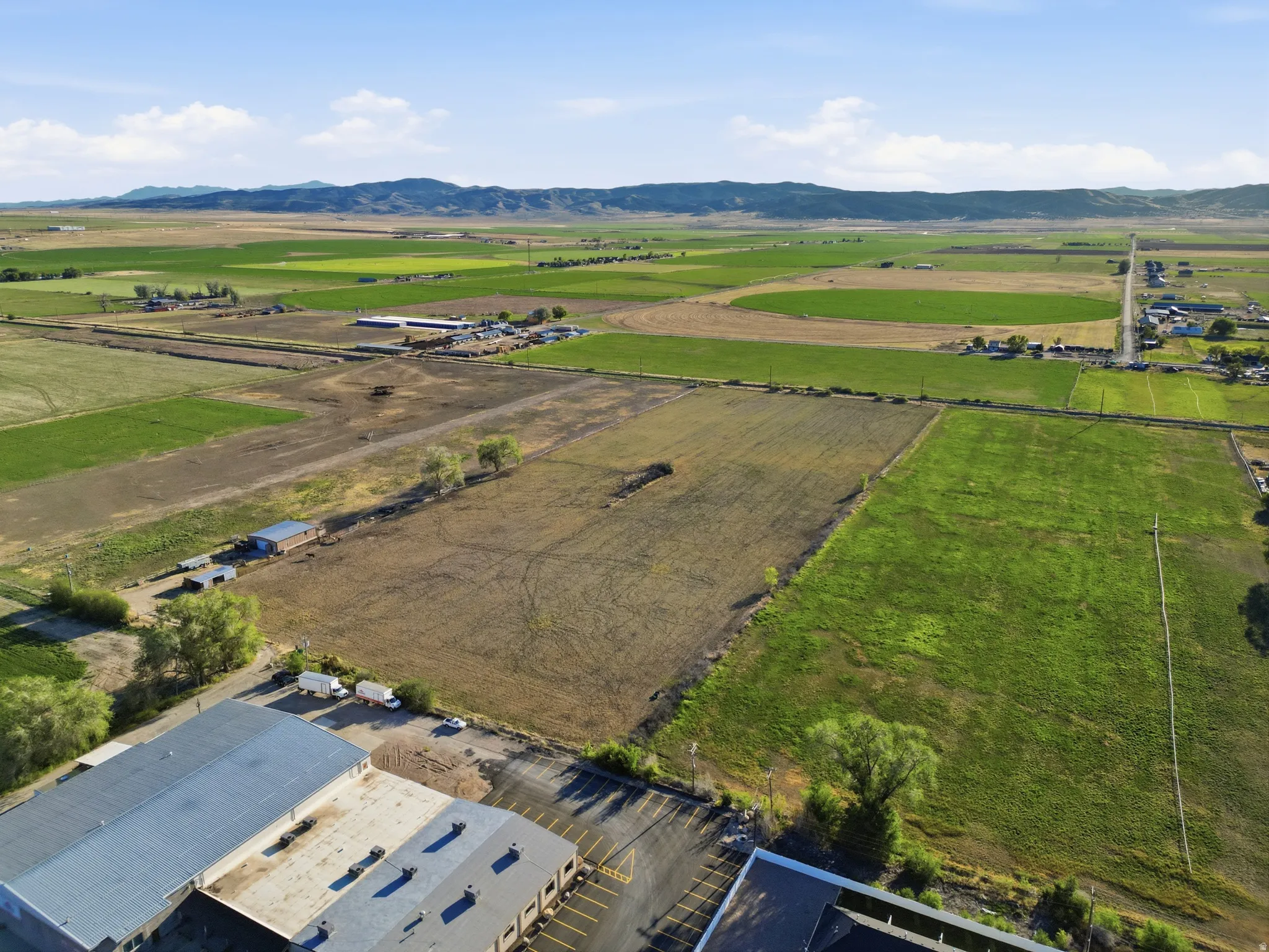 Expansive rural landscape featuring a mix of open fields and cultivated agricultural areas
