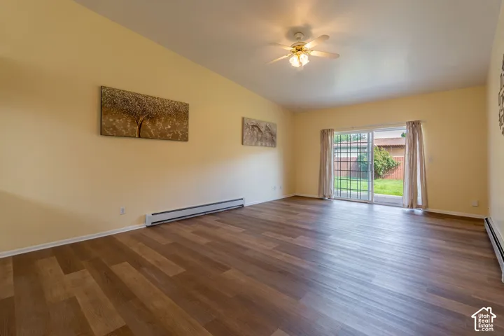 Spacious interior featuring wood-finish flooring, vaulted ceilings, and light-toned walls