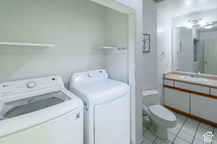 Laundry area featuring a top-load washer and front-load dryer