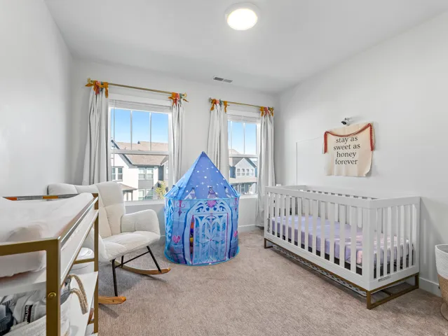 Room featuring light-colored walls and neutral carpet flooring