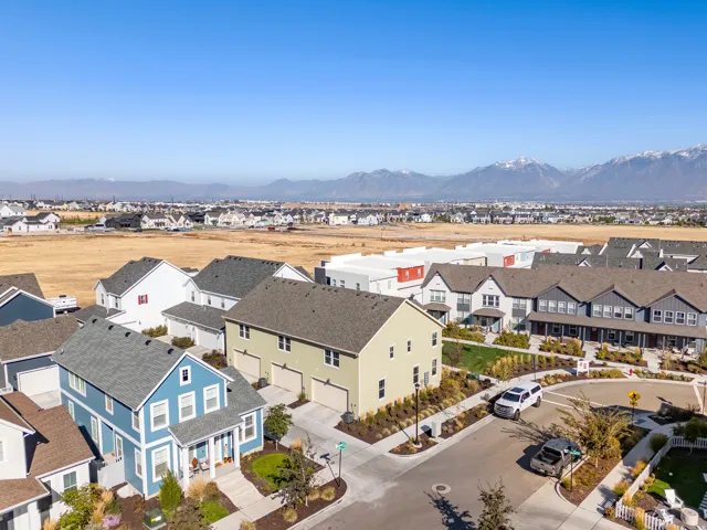 Residential development featuring a variety of single-family homes and townhomes with pitched roofs