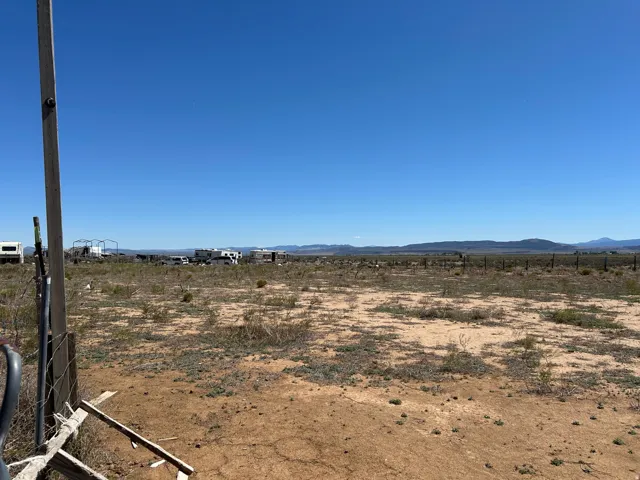 Expansive land parcel featuring desert landscaping and distant mountain ranges