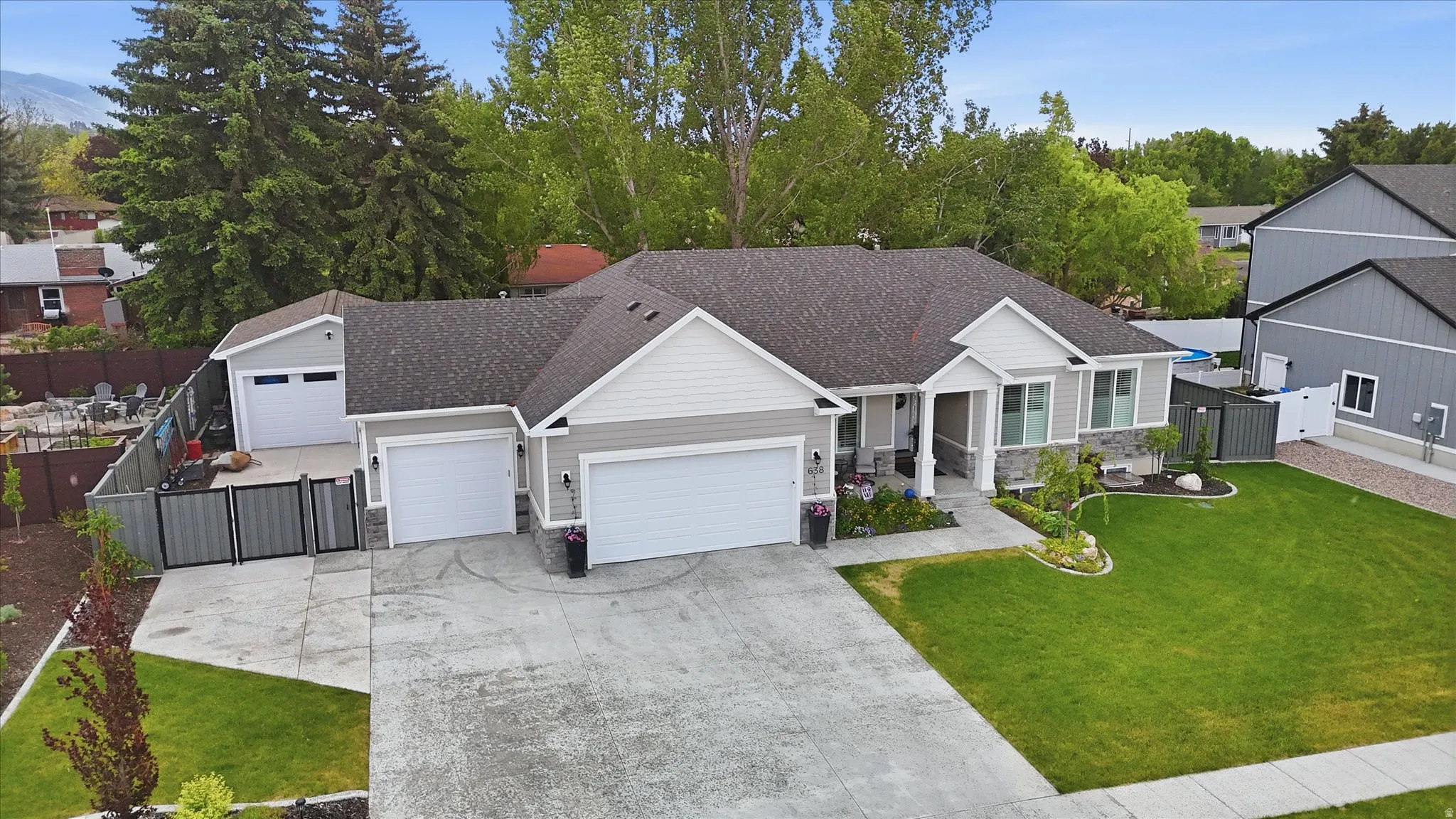 Contemporary home with a two-car garage, an additional detached single-car garage, and a concrete driveway