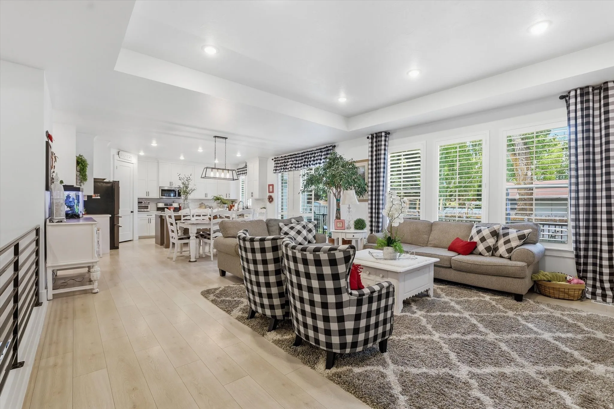 Open-concept living space featuring wood-finish flooring and recessed lighting