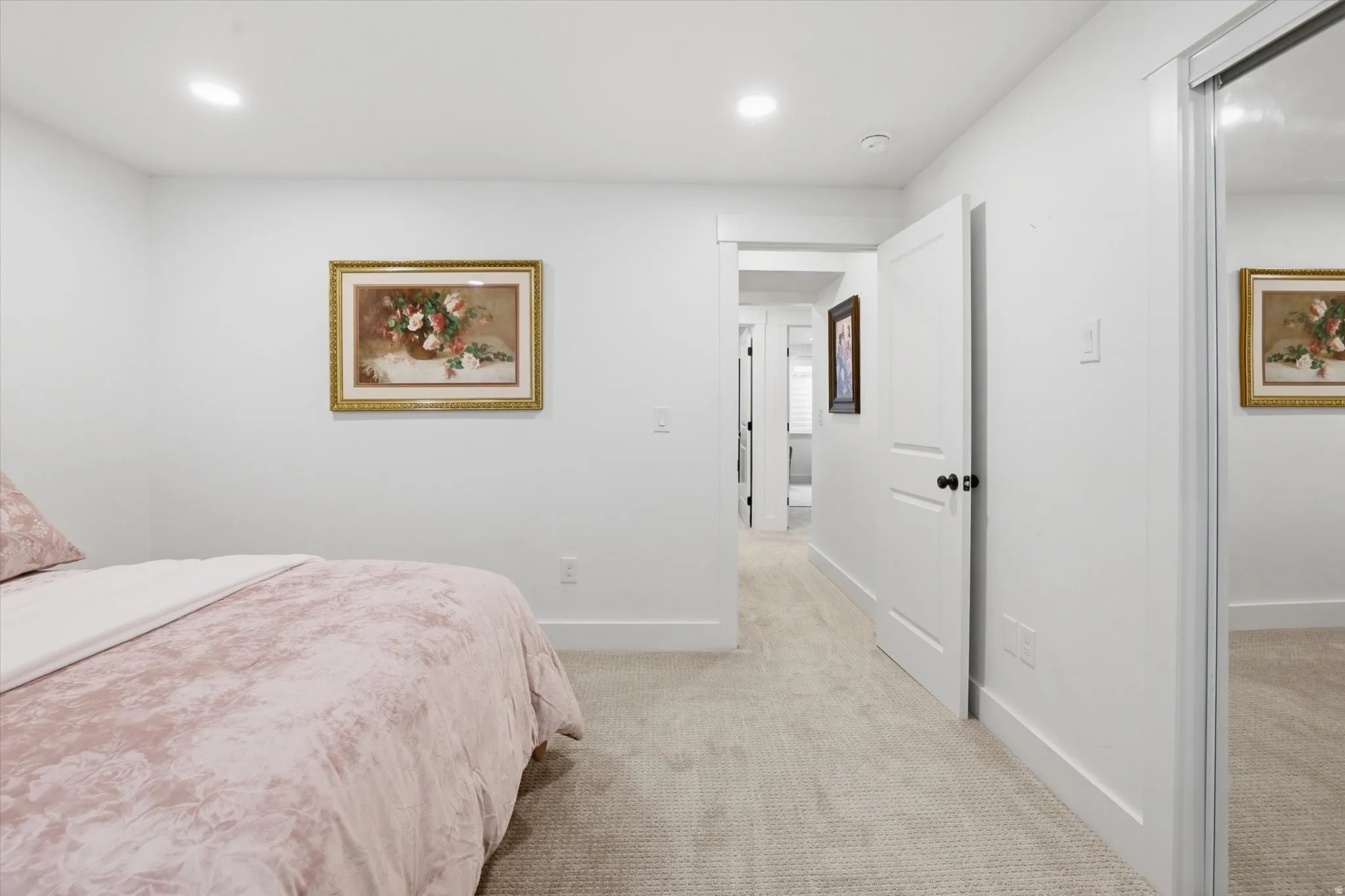 Carpeted room featuring white walls, recessed lighting, and a mirrored closet door