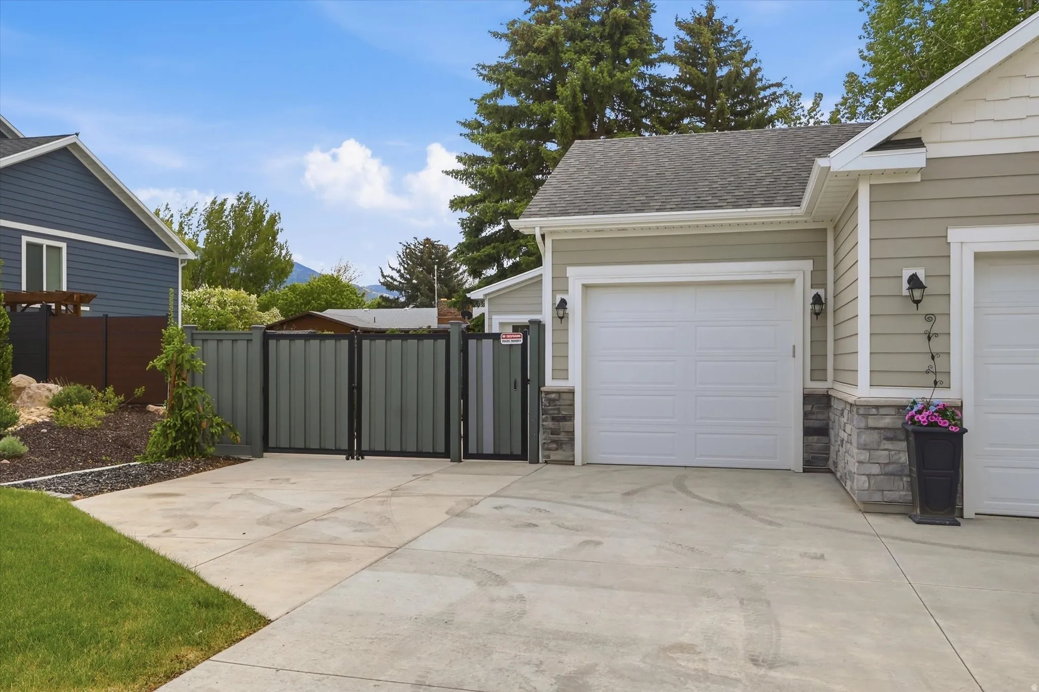 Concrete driveway leading to an attached garage with a white panel door