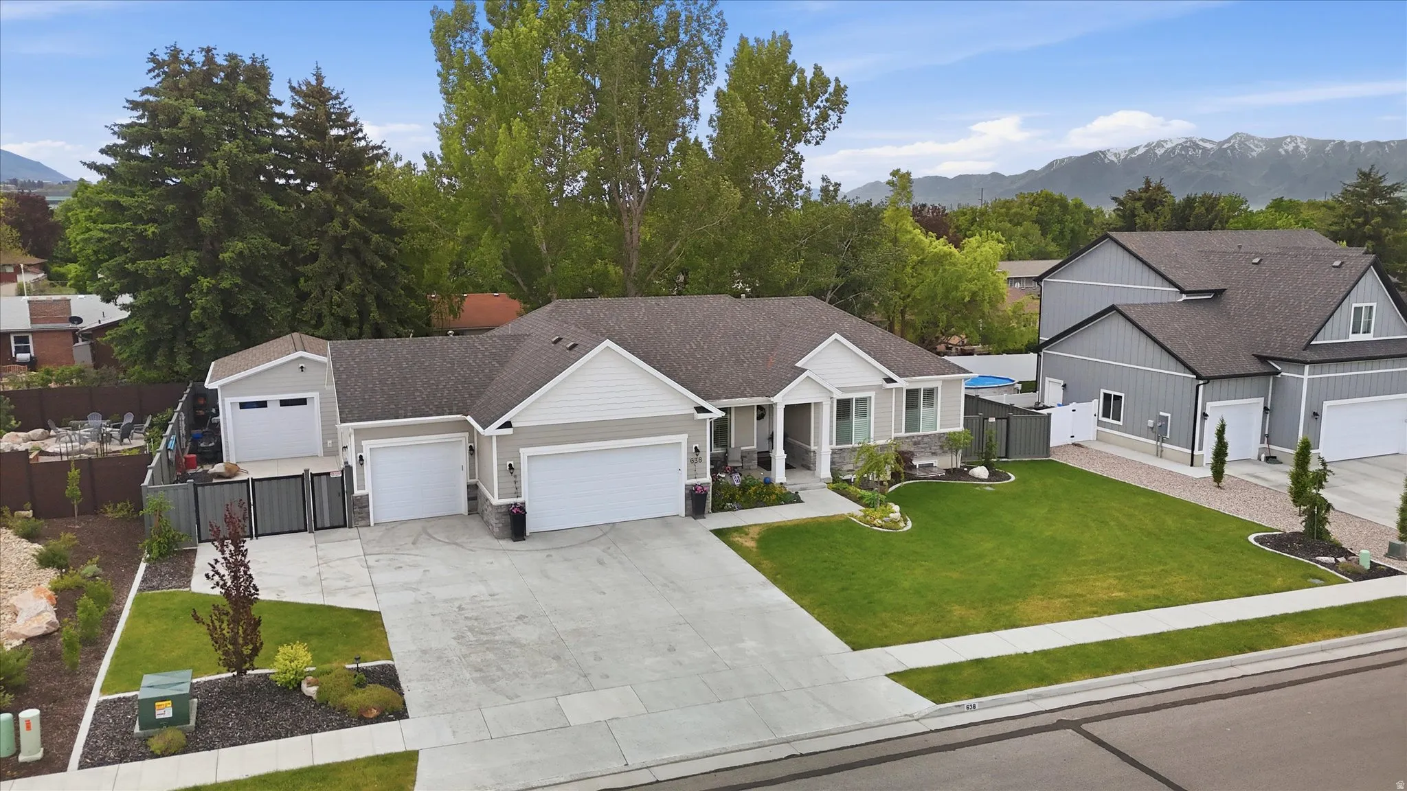 Ranch-style exterior with light gray siding and white trim