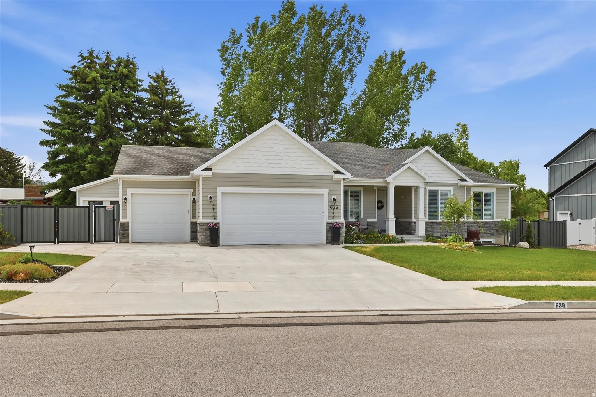 Ranch-style residence featuring light gray siding and white trim