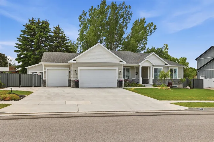 Ranch-style residence featuring light gray siding and white trim