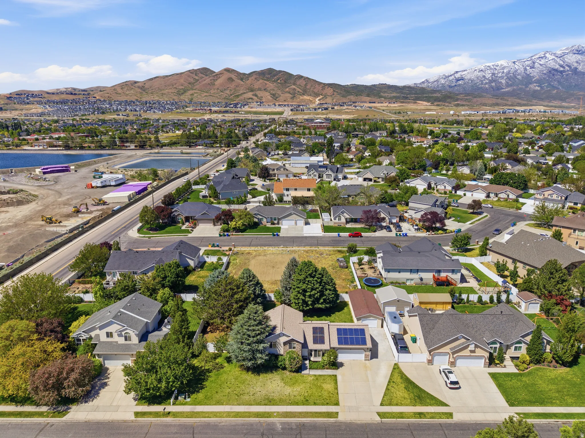 Expansive aerial perspective showcasing a residential neighborhood with distant mountain ranges