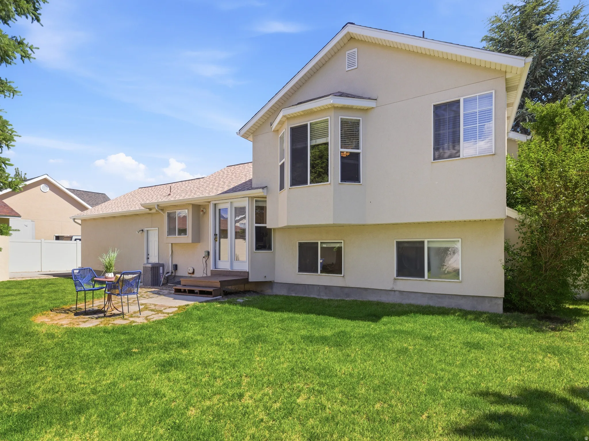 Rear exterior with stucco siding and a bay window