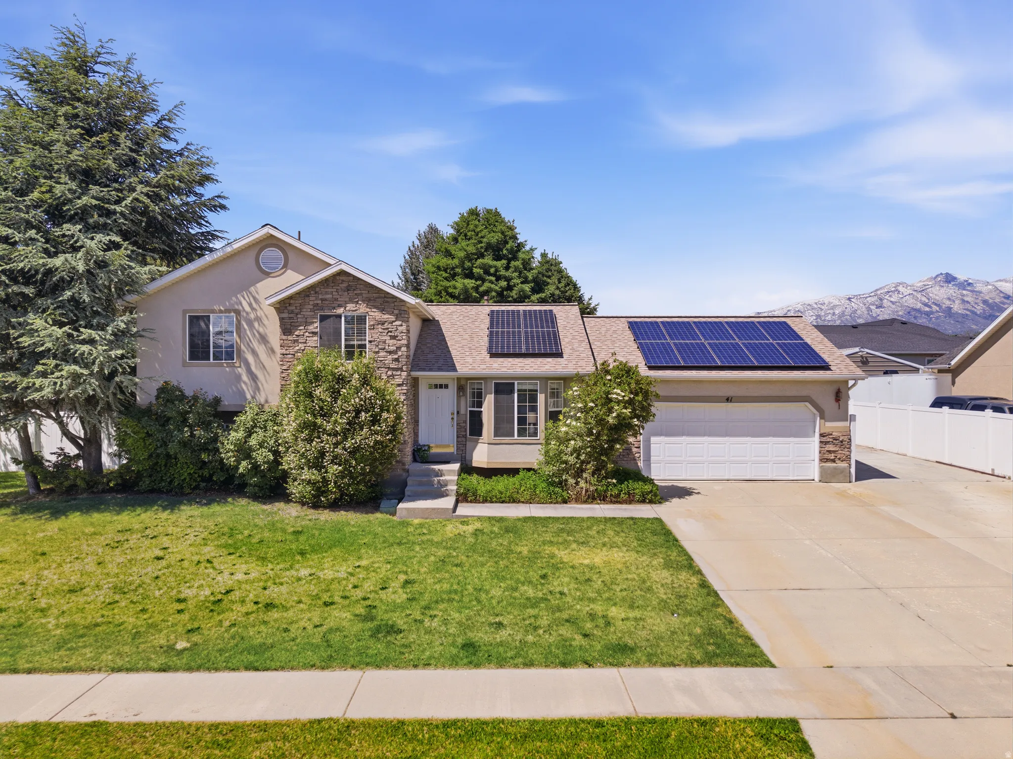 Front exterior featuring stone accents and a two-car garage