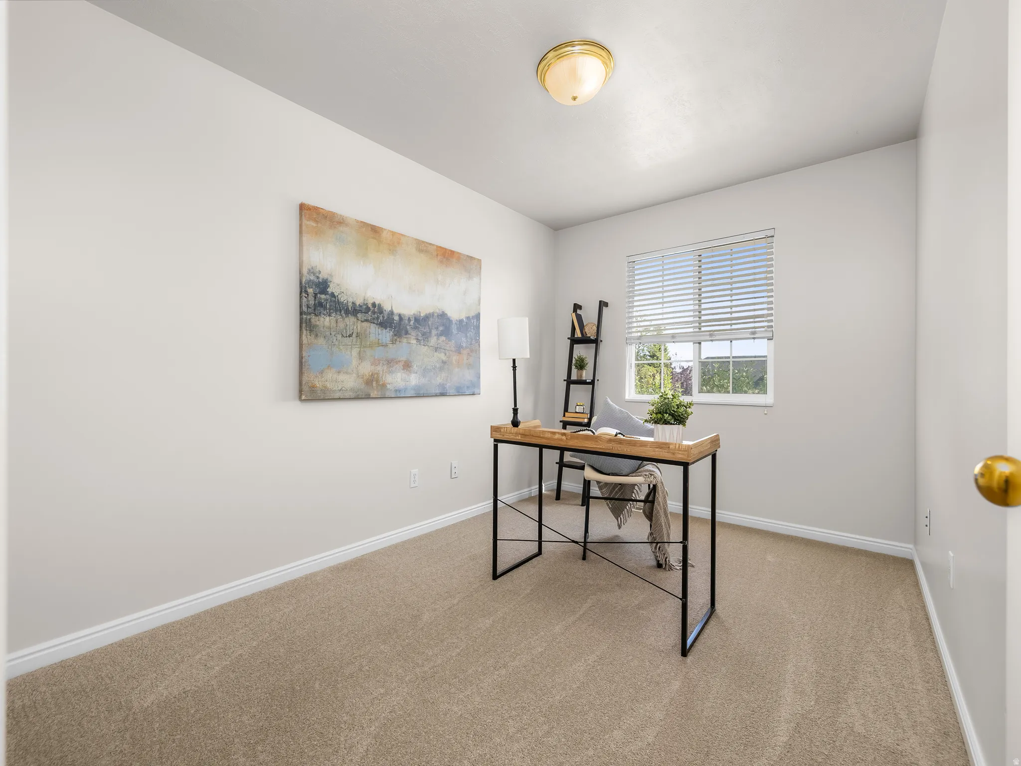 Light-filled room featuring neutral carpeting and light-toned walls