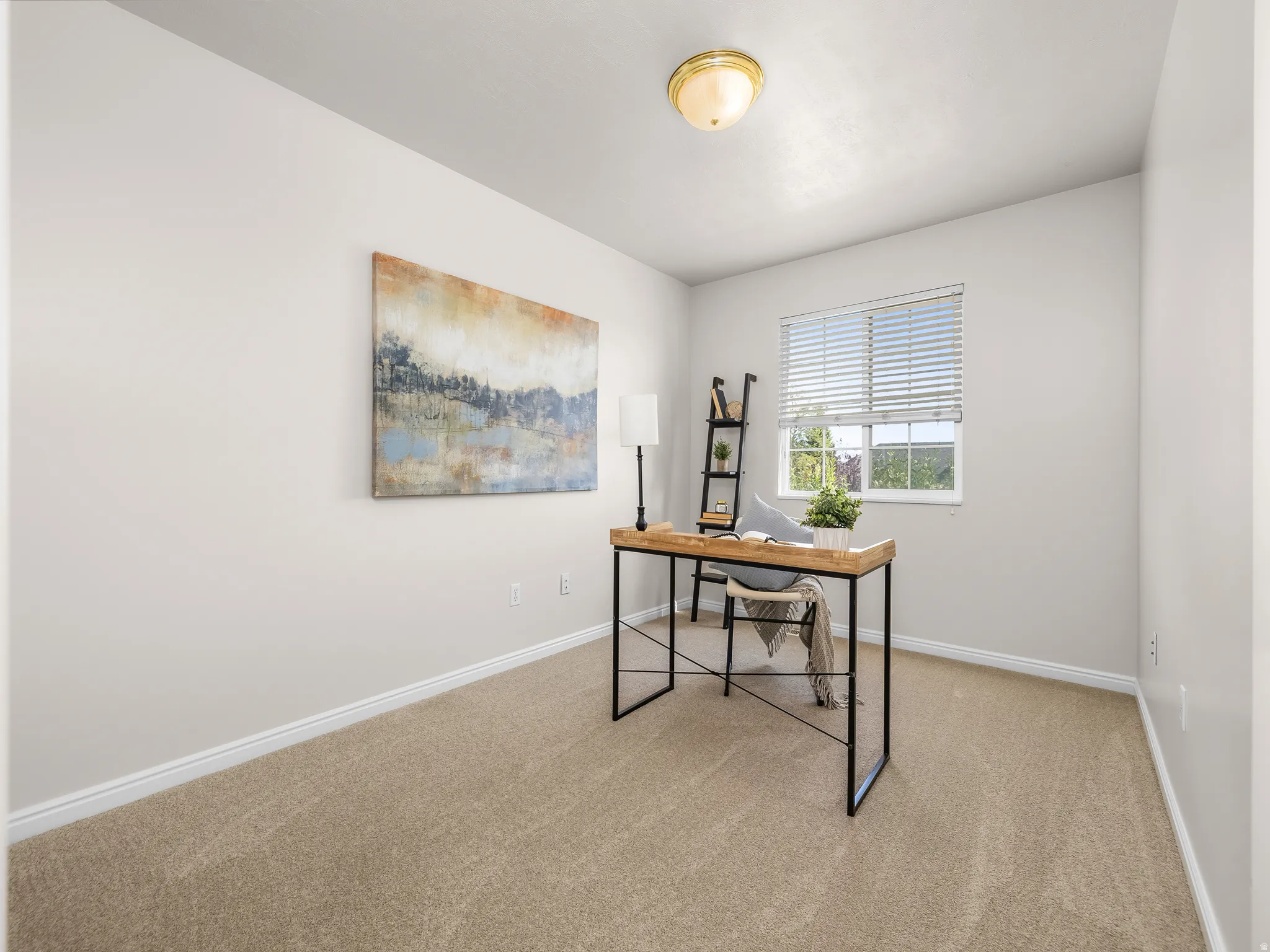 Room with light tan carpeting, a window with horizontal blinds, white baseboards, and a flush-mount ceiling light fixture