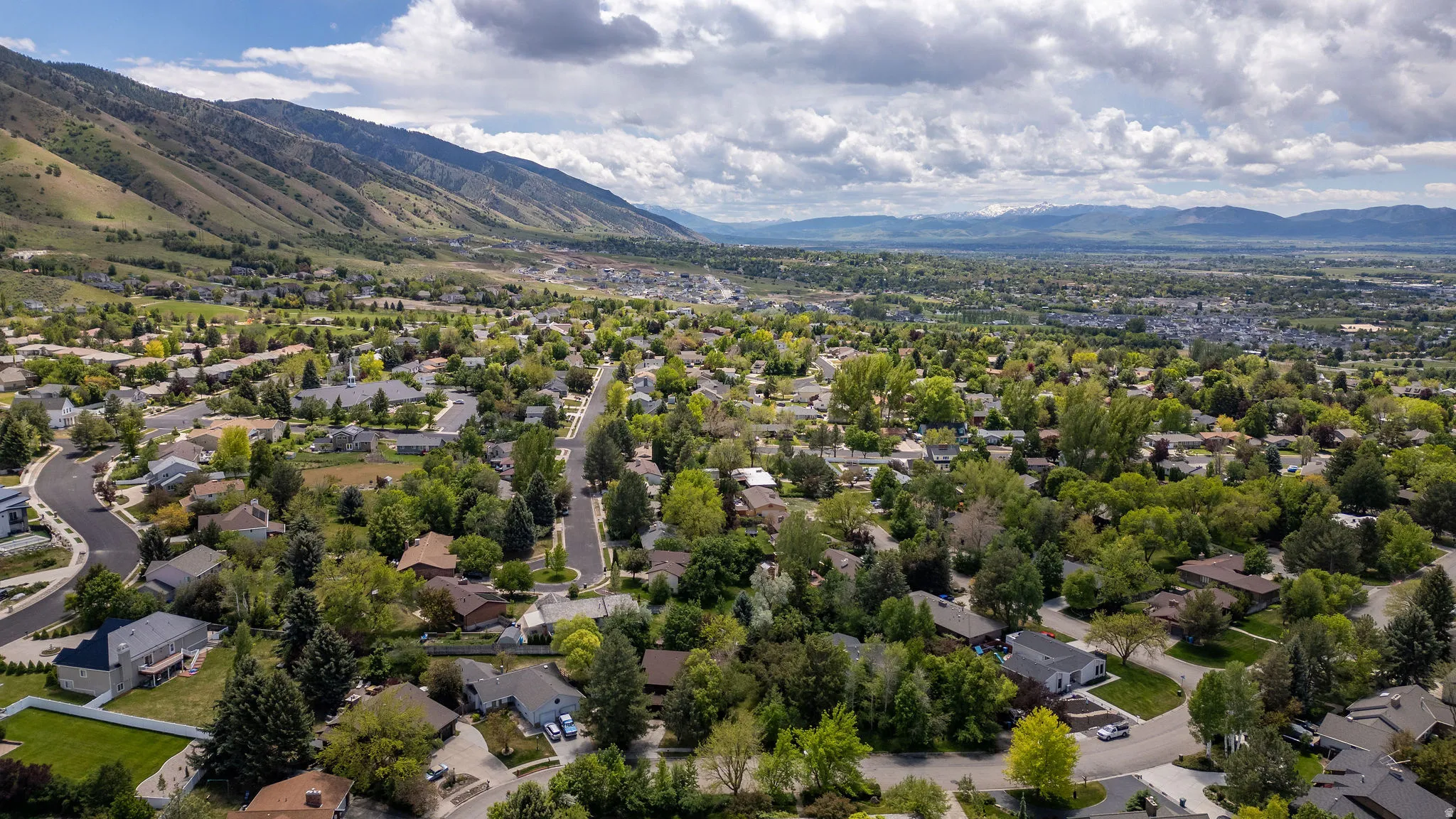 Expansive residential area featuring established homes, mature trees, and paved roads