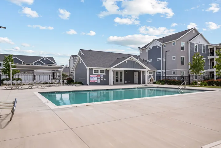 Outdoor swimming pool with integrated steps, surrounded by a concrete deck