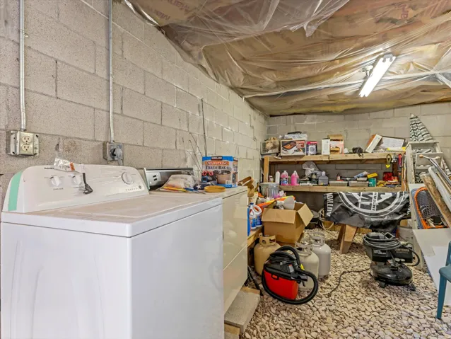 Concrete block walls with exposed conduit and electrical outlets provide utility space
