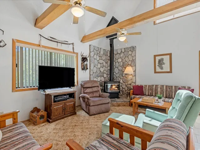 Vaulted ceiling with exposed wood beams and ceiling fans
