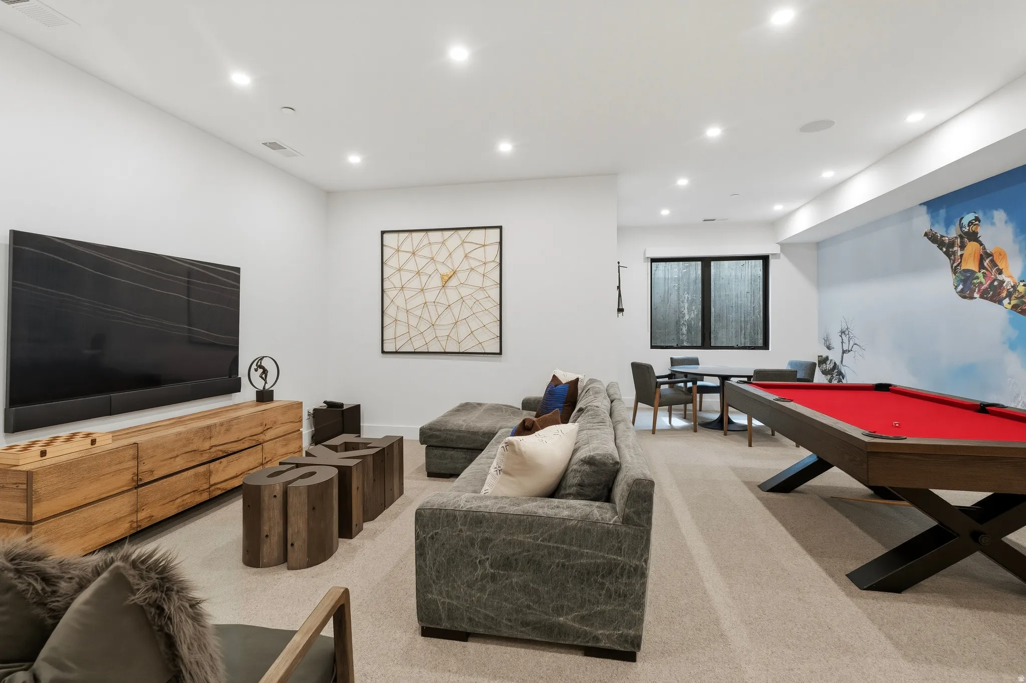 Spacious living room featuring recessed lighting, poker table, pool table, and TV area