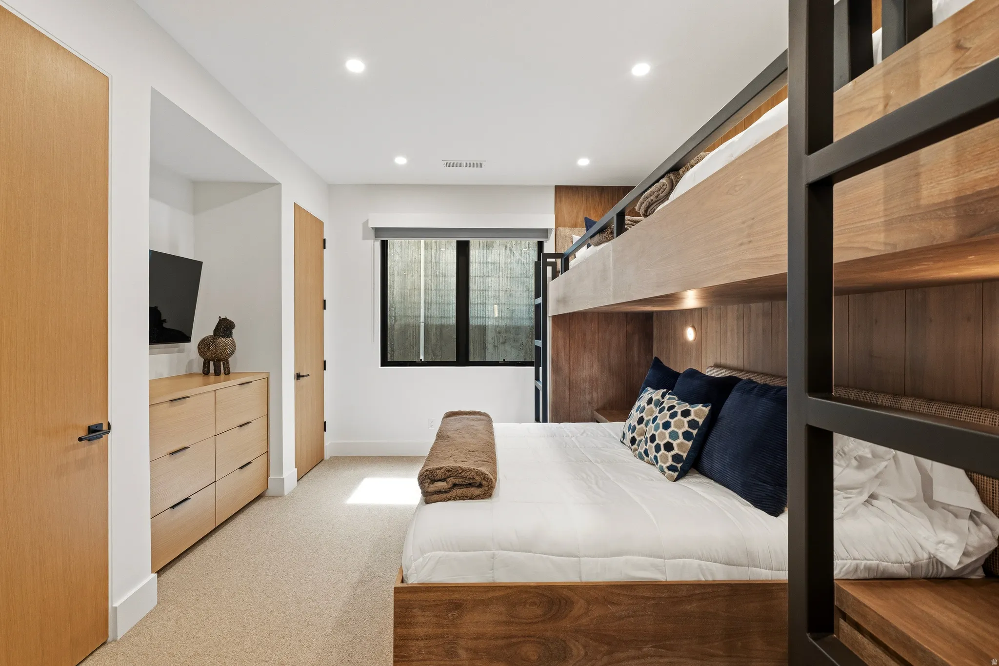 Built-in bunk bed structure featuring wood-finish paneling and integrated lighting