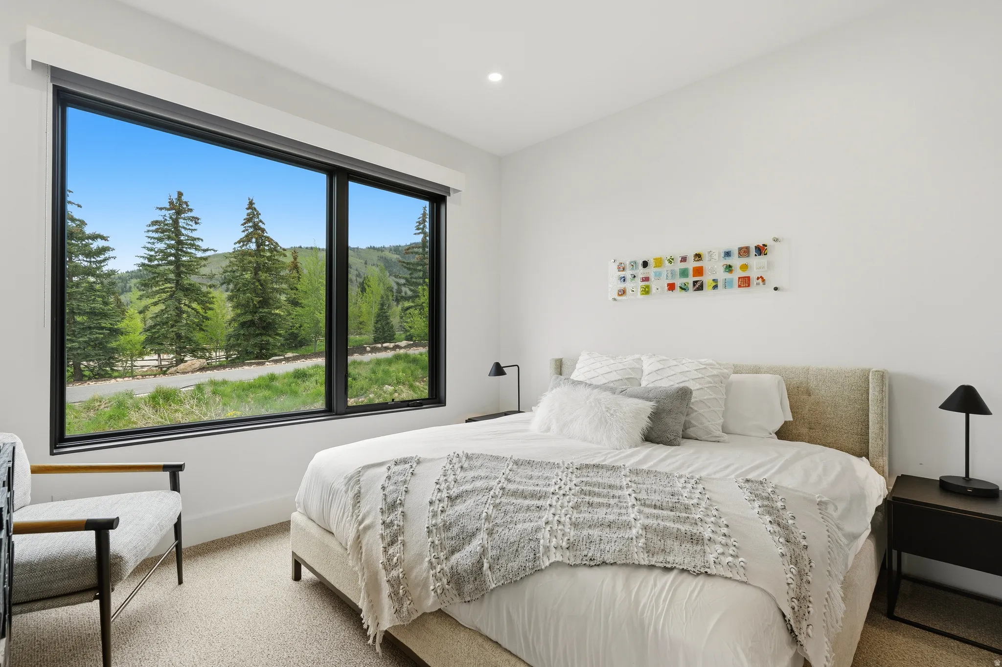 Expansive picture window framing a wooded landscape