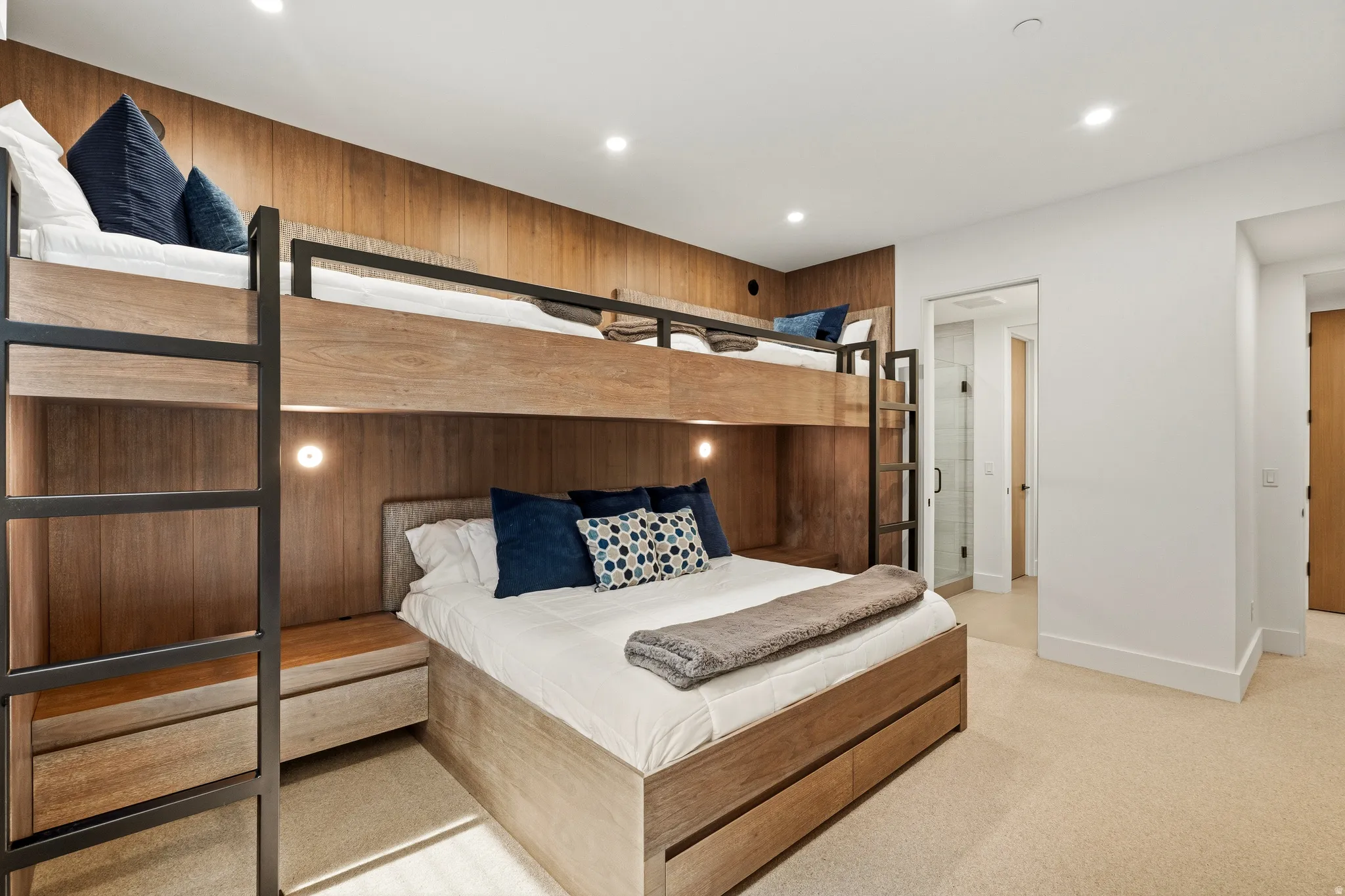 Integrated bunk beds featuring wood-finish paneling and black metal accents