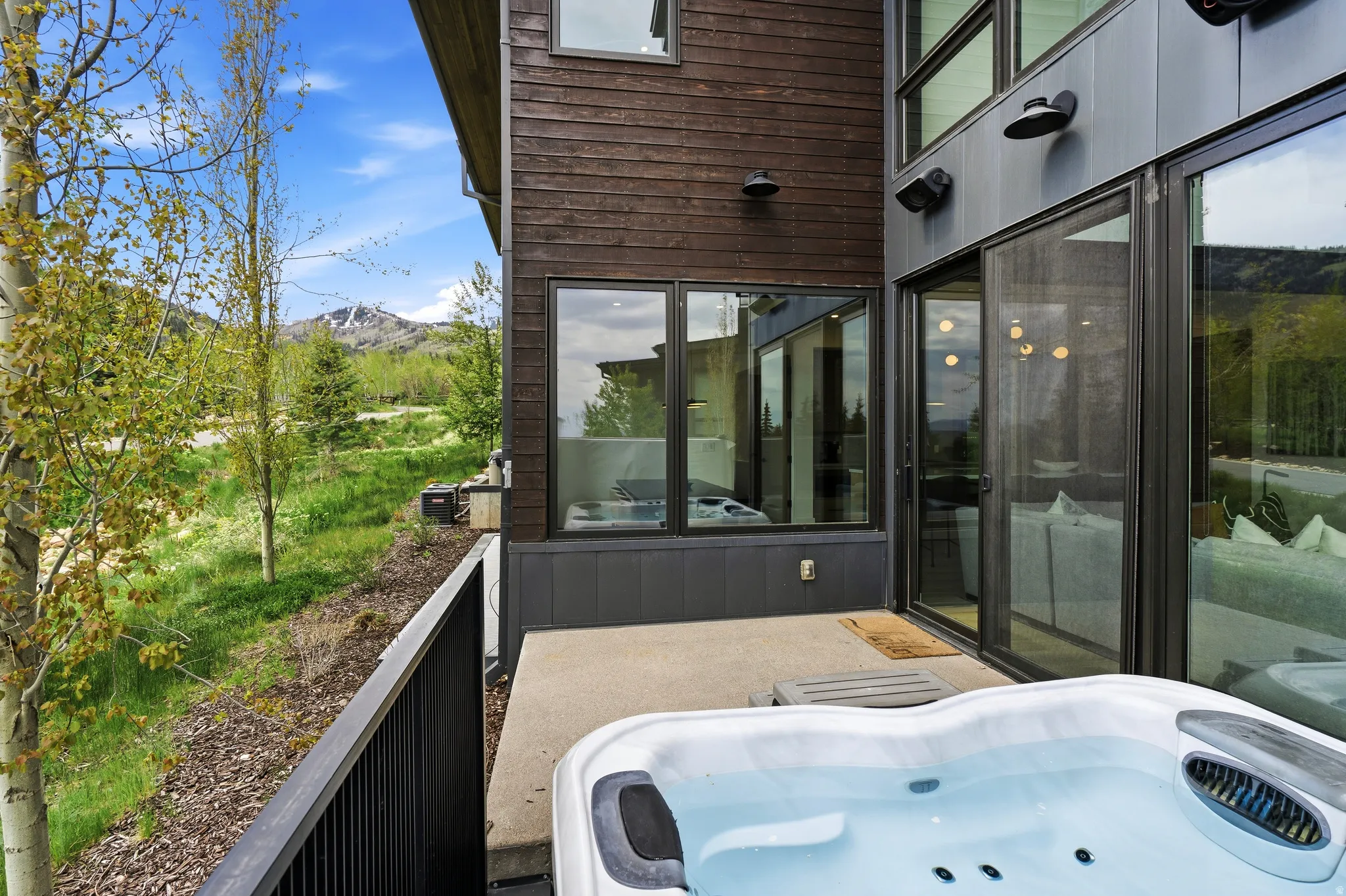 Private patio featuring a hot tub and mountain views.
