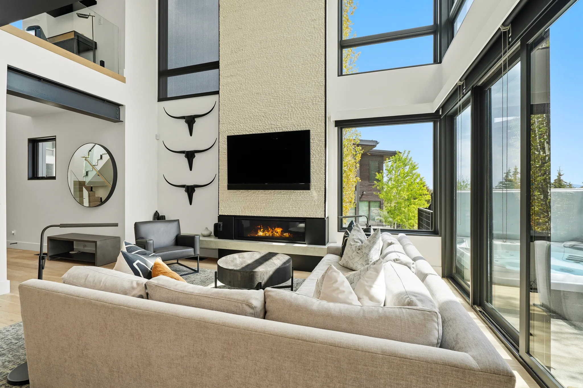 Living area with a two-story textured fireplace wall and linear fireplace