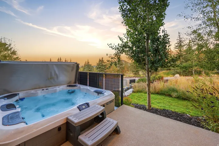 Outdoor spa with steps on a concrete patio
