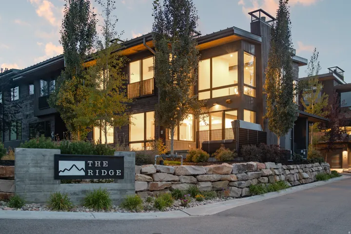Modern architectural design featuring expansive windows and dark-toned siding