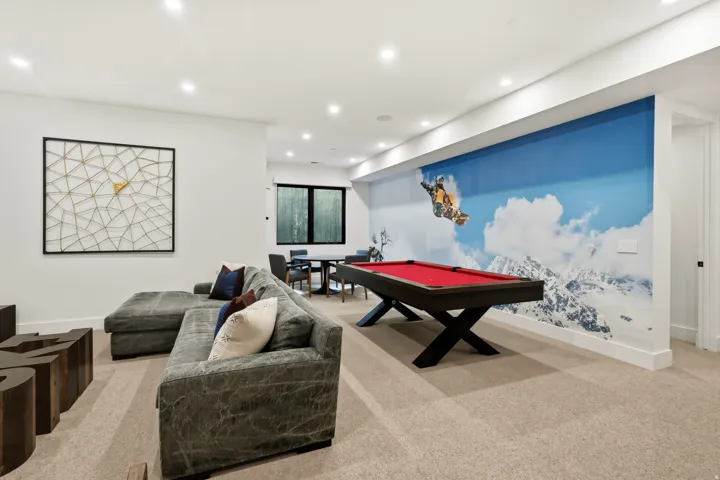 Spacious living room featuring recessed lighting, poker table, pool table, and TV area
