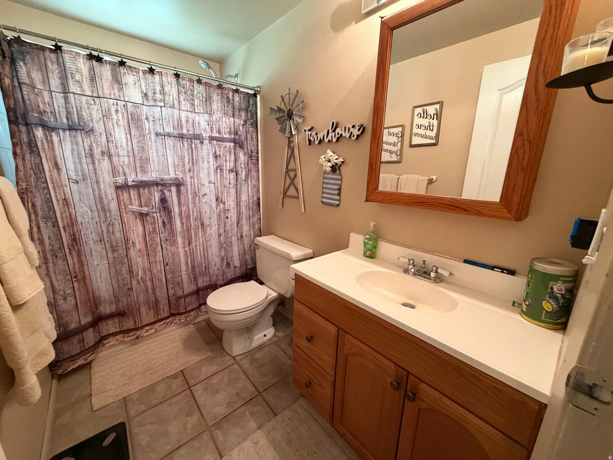 Bathroom featuring a light wood-finish vanity with a white countertop and integrated sink
