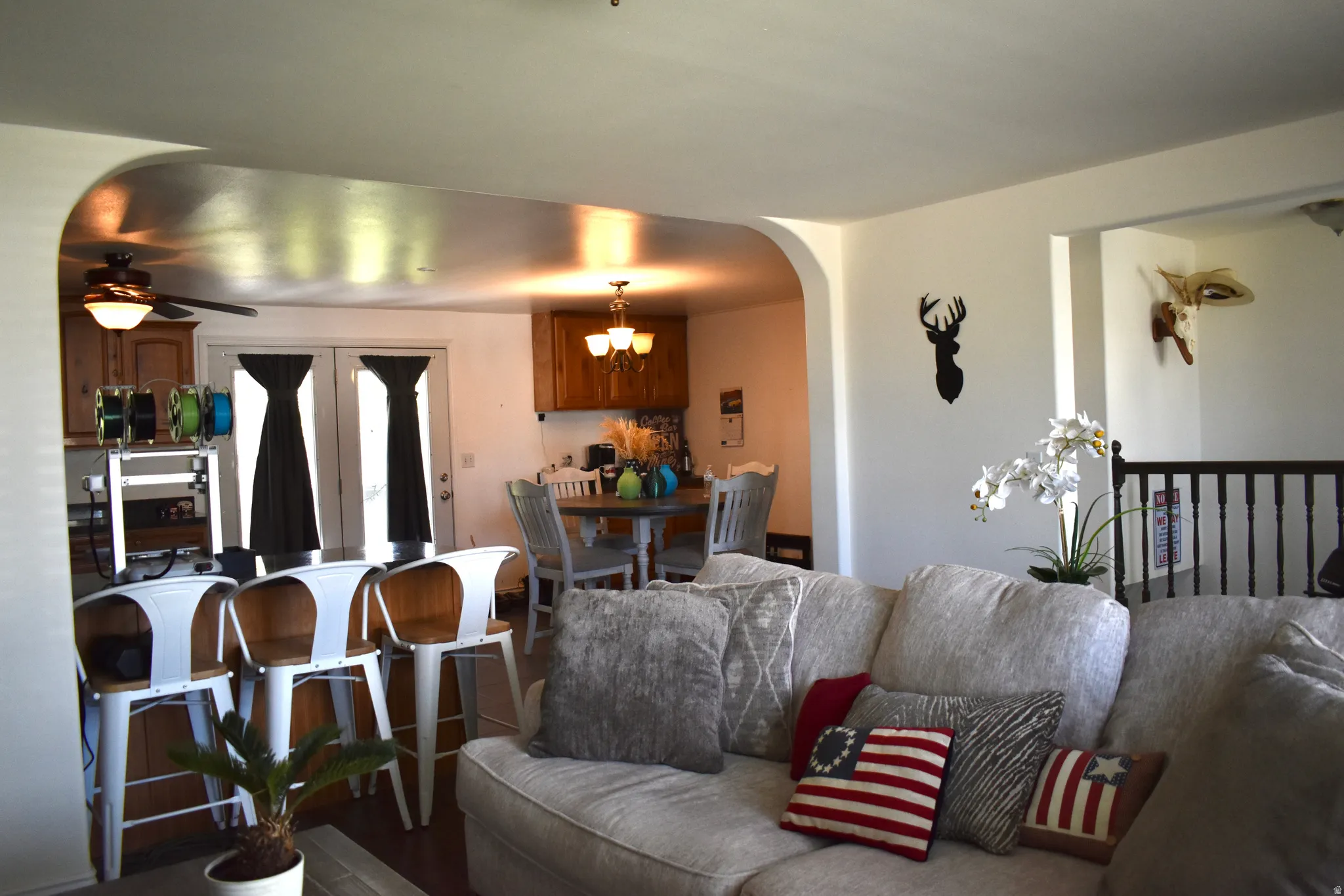 Open-concept interior featuring light-toned walls and wood-finish flooring