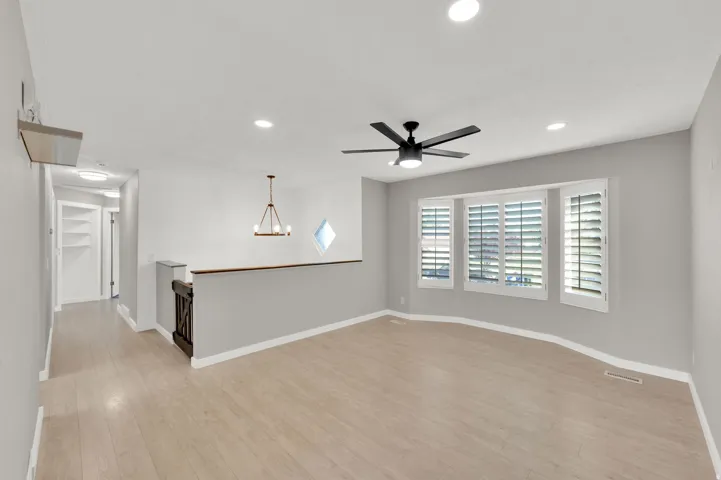 Light wood-finish flooring complements the neutral wall tones