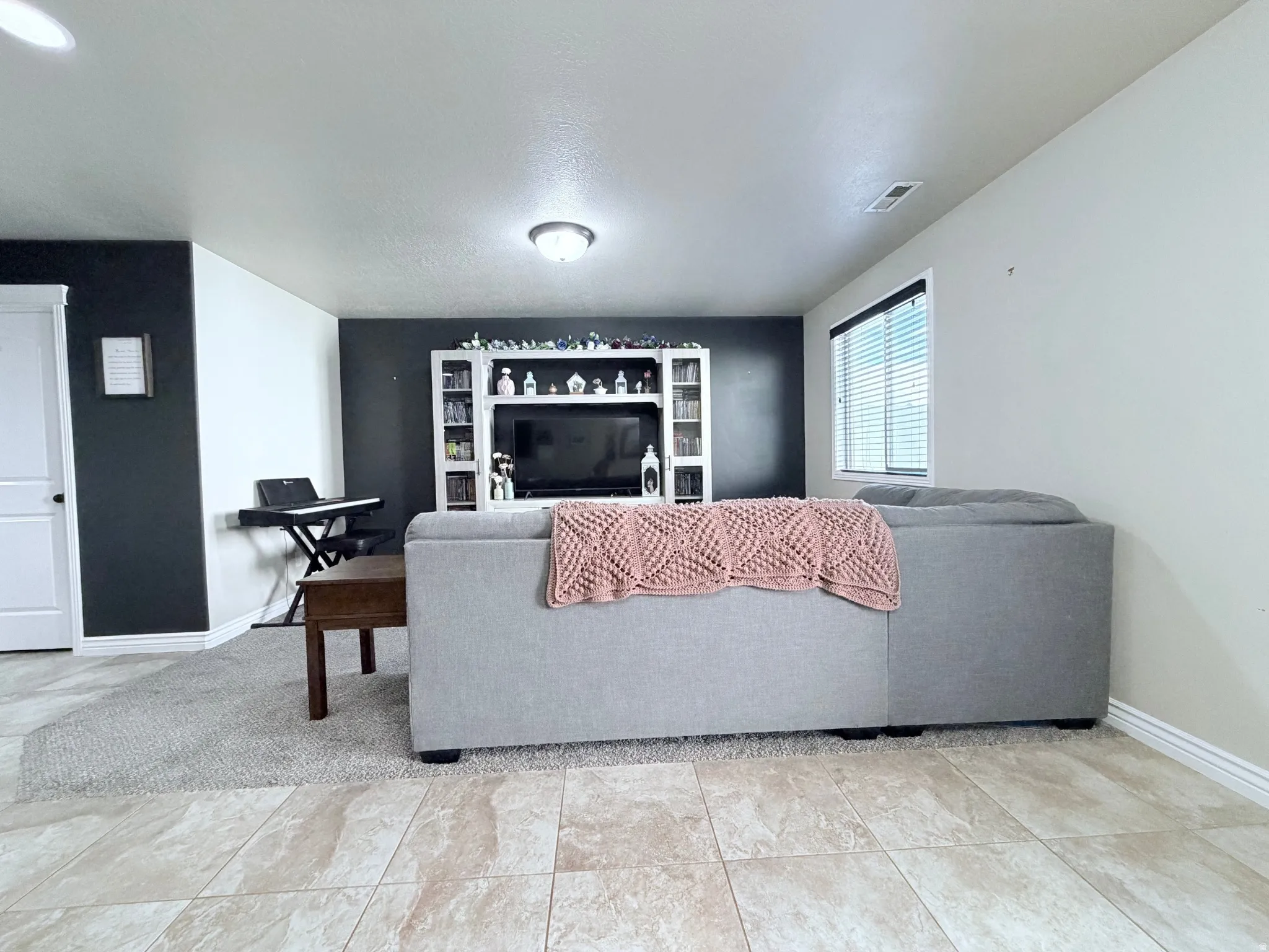 Spacious living area featuring a dark accent wall