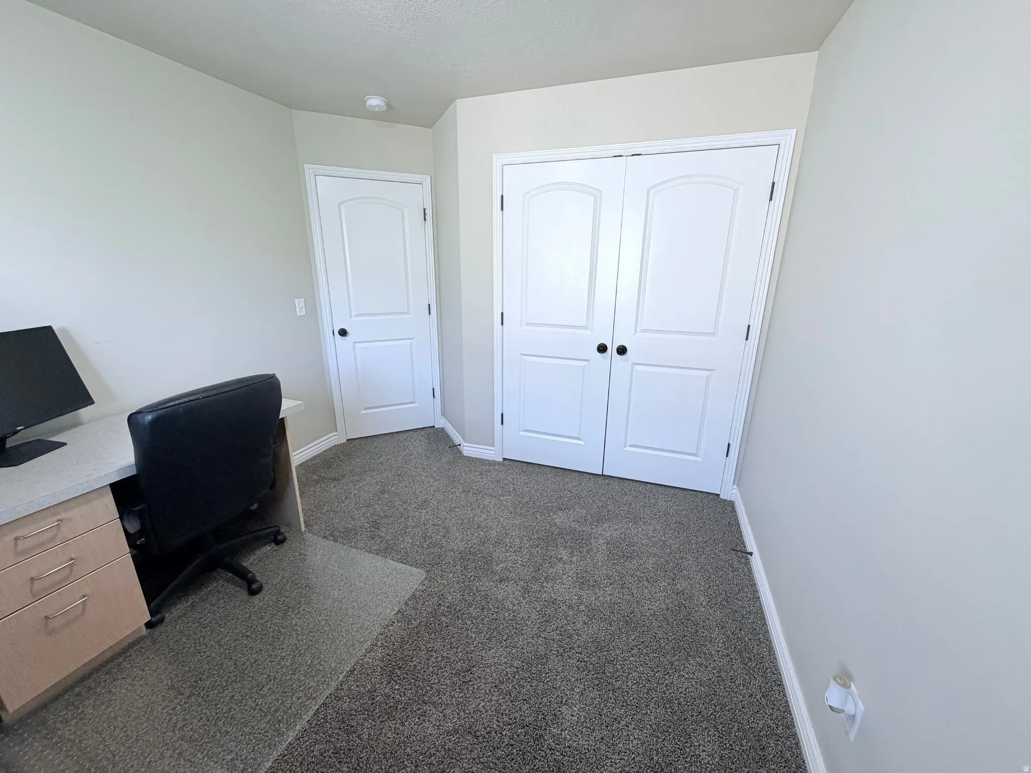 Another view of bedroom #3 with neutral wall paint and contrasting white trim