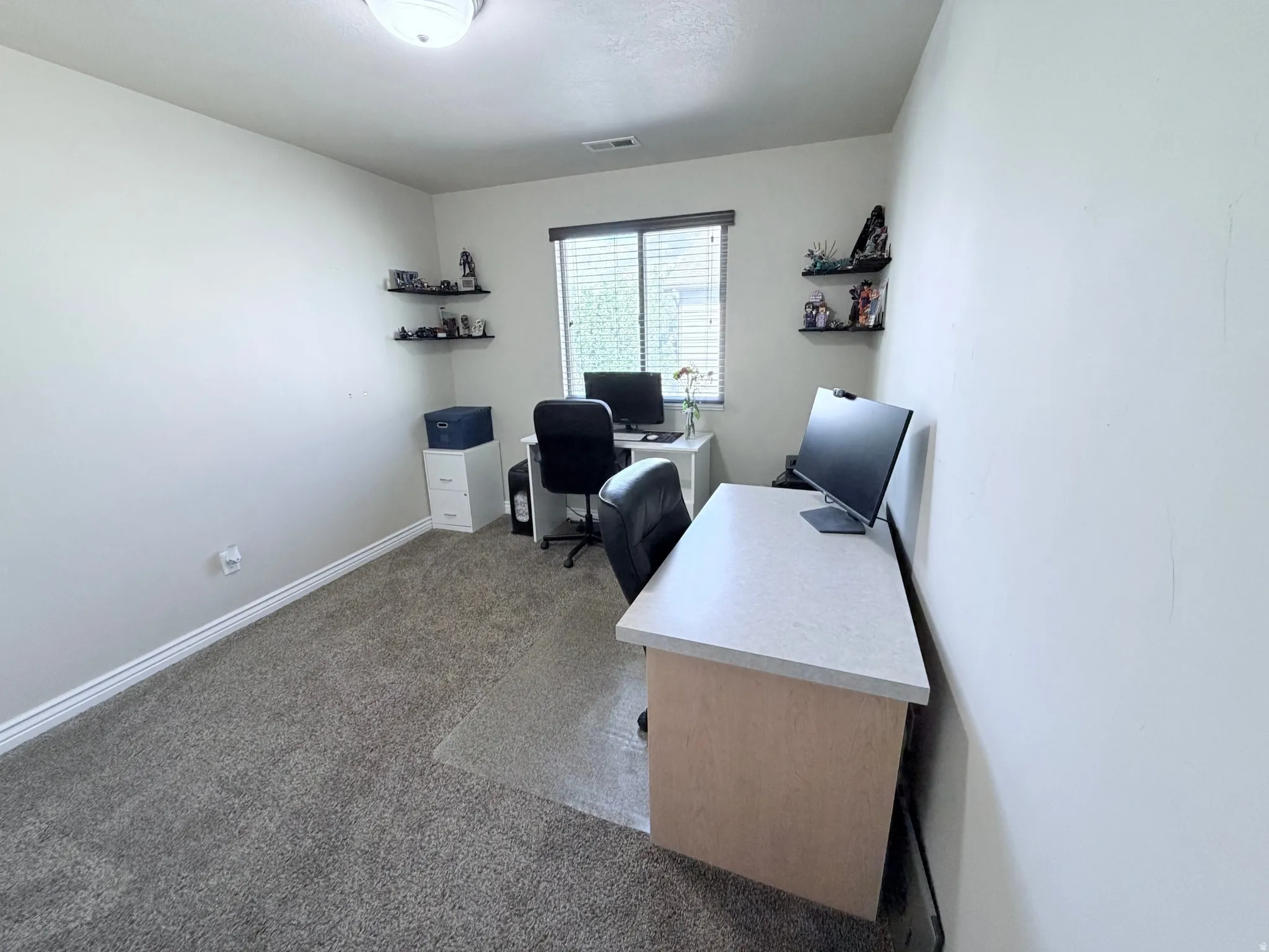 Bedroom #3 or home office with light walls and neutral carpeting