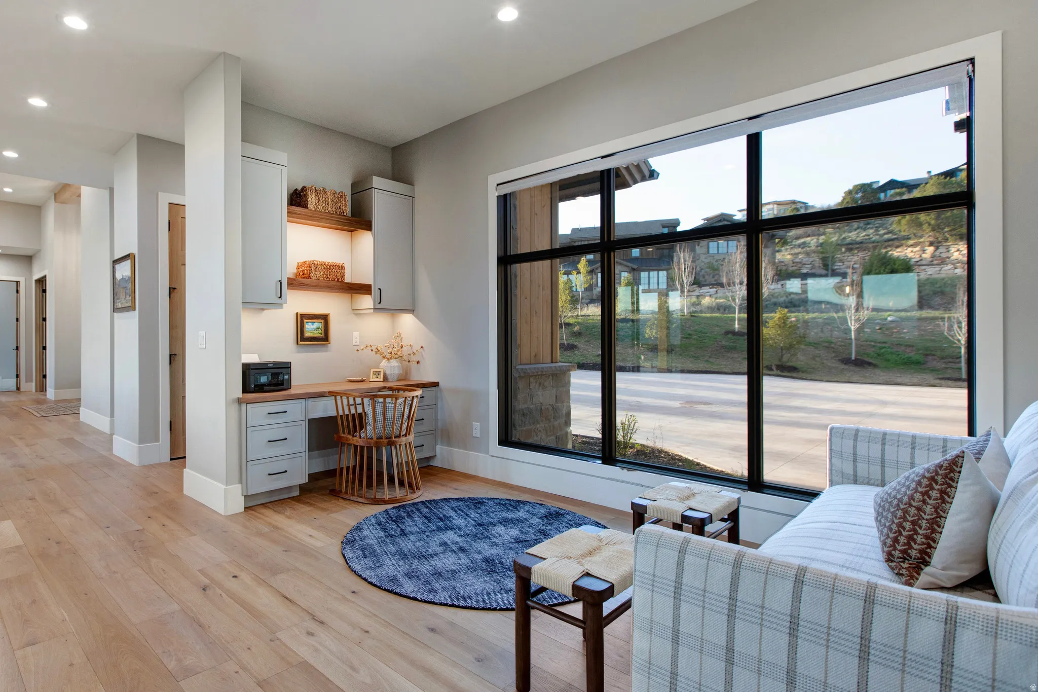 Built-in desk area with under-cabinet lighting and open shelving