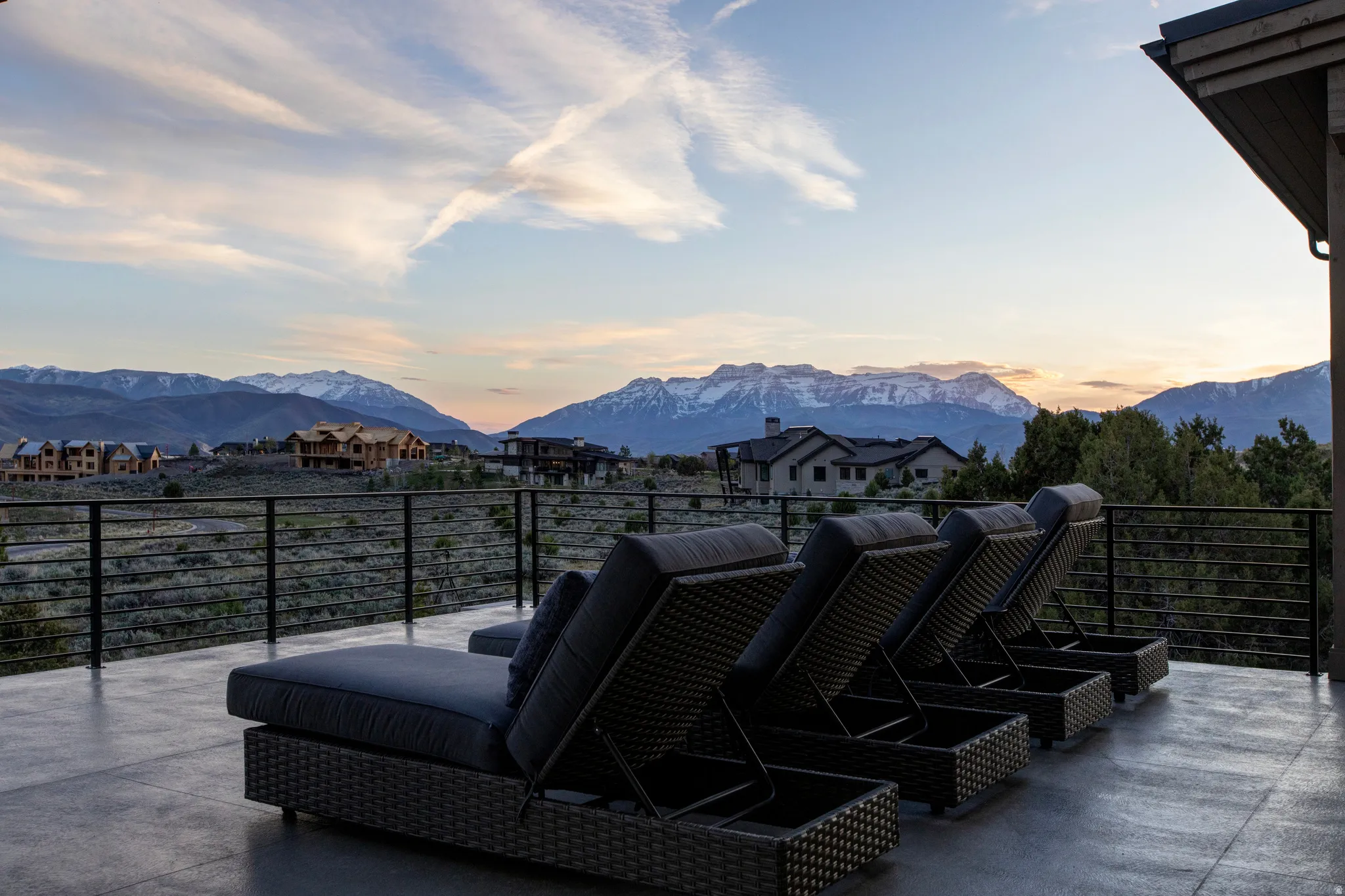 Spacious outdoor deck featuring a concrete surface and a sleek horizontal cable railing