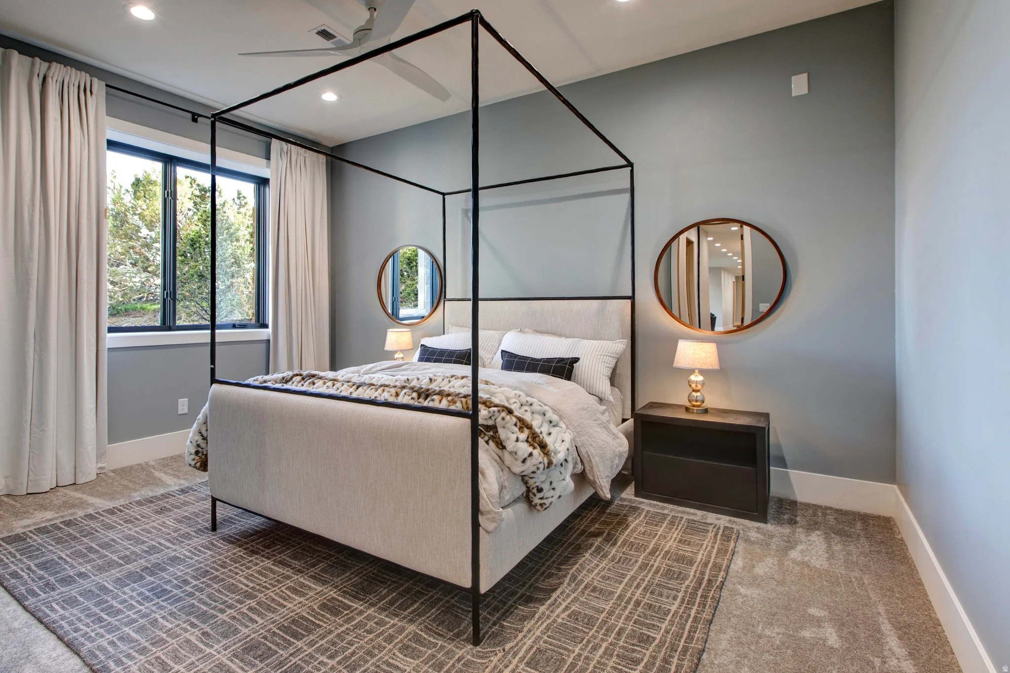 Bedroom featuring a canopy bed, recessed lighting, and a ceiling fan