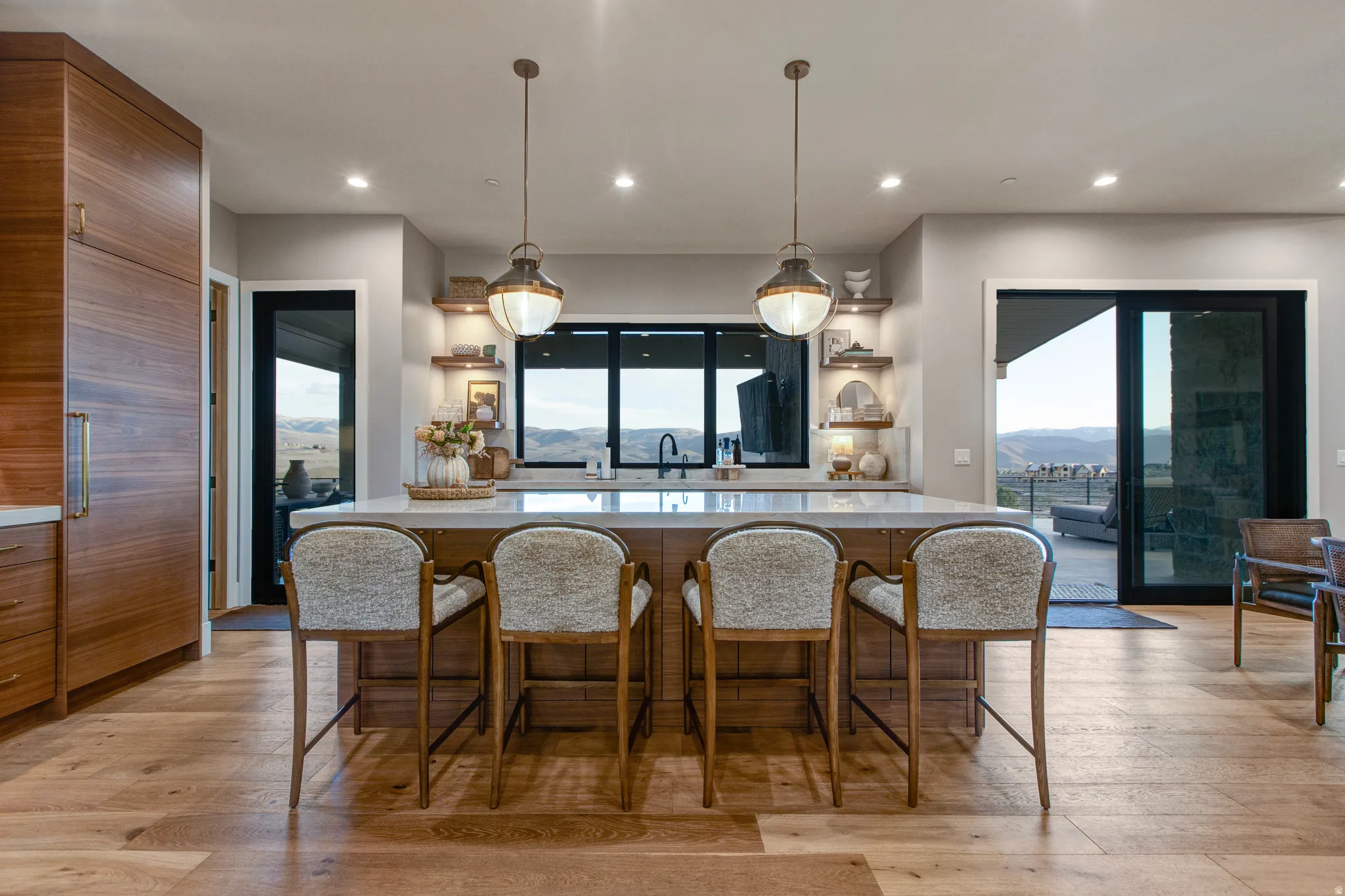 Spacious kitchen island with seating for four, set against wood-finish flooring