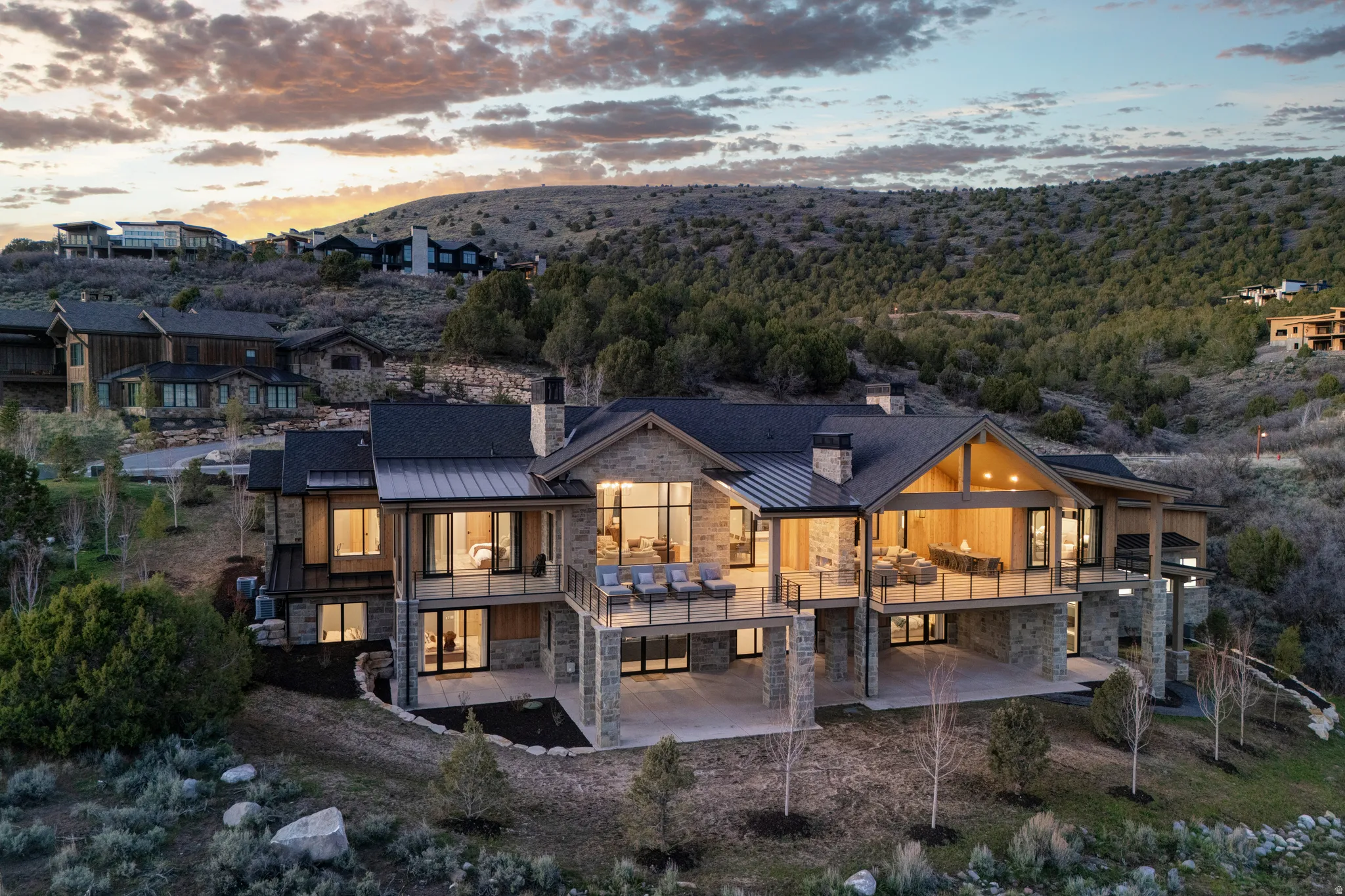 Contemporary multi-level residence featuring extensive stone and wood siding