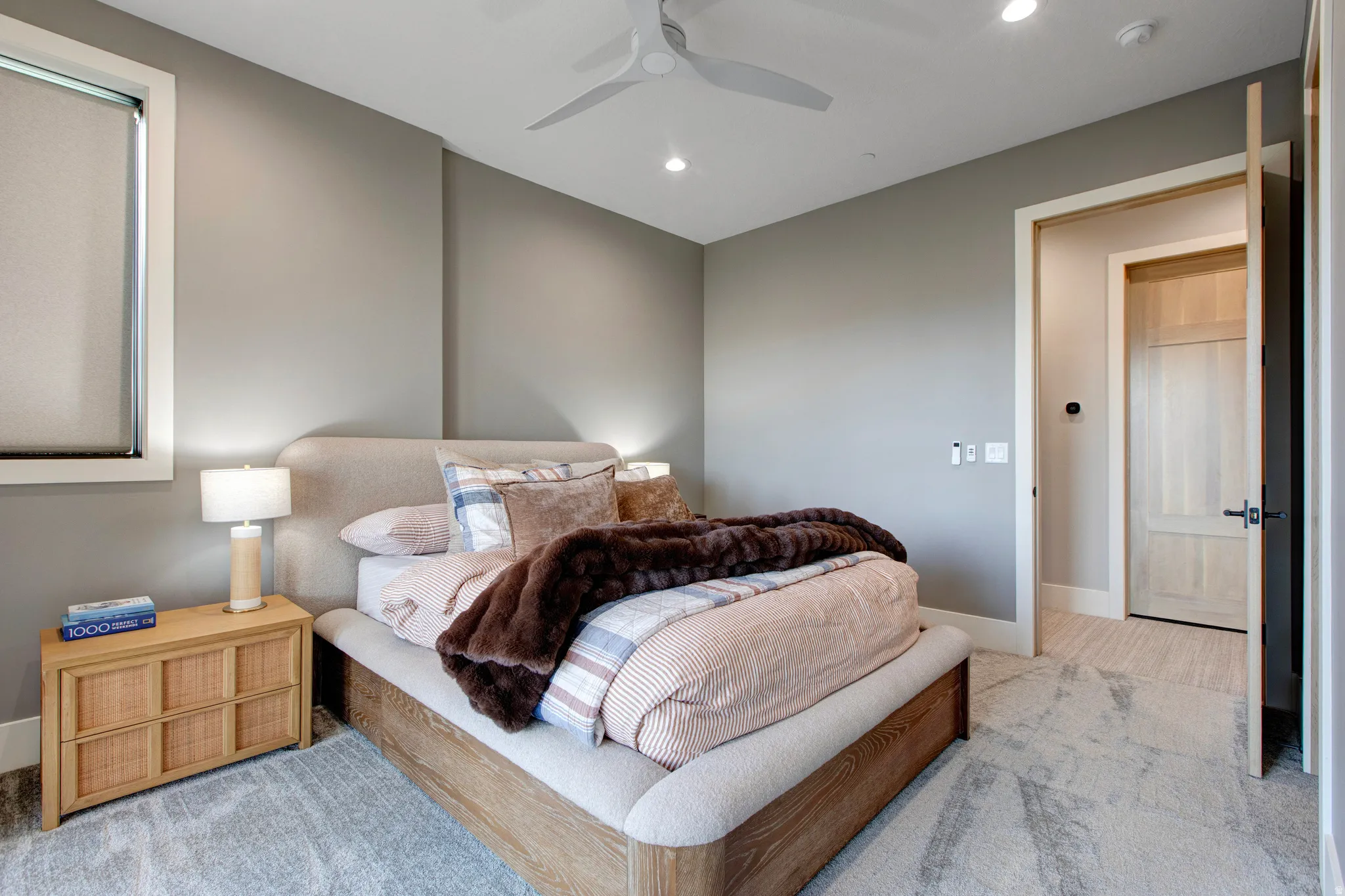 Carpeted room featuring a ceiling fan, recessed lighting, and a neutral color palette