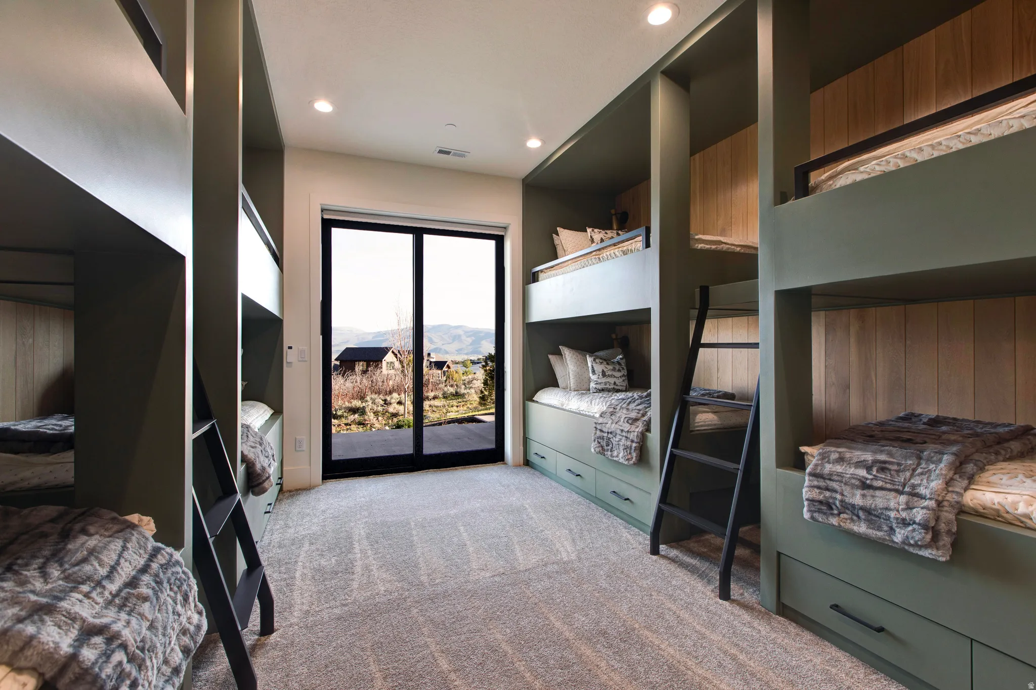 Built-in sleeping areas featuring integrated storage drawers and accent lighting