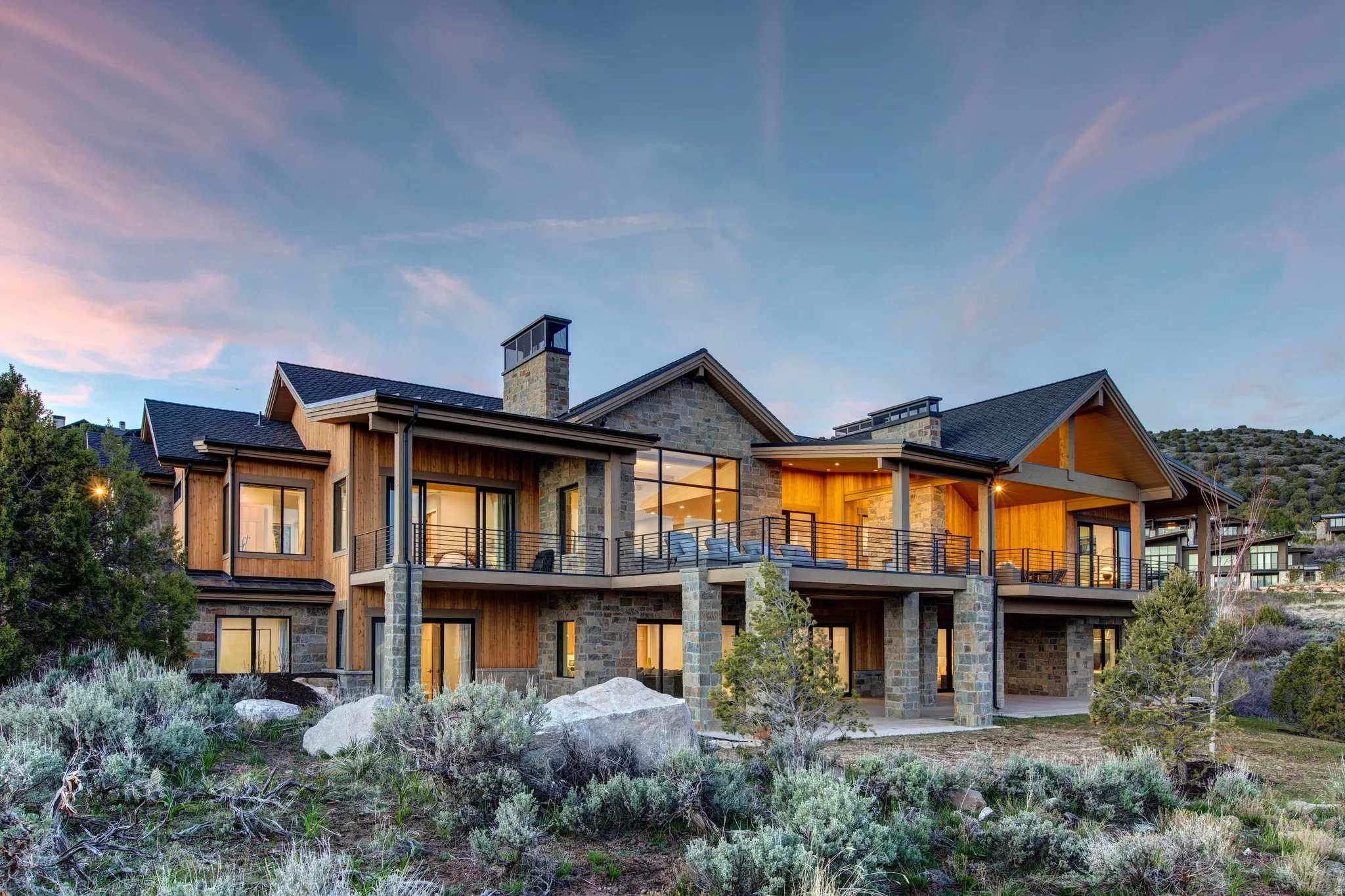Multi-level residence featuring stone and wood-panel exterior accents
